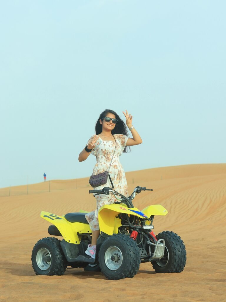 A girl standing on a Quad Bike in best desert safari abu dhabi